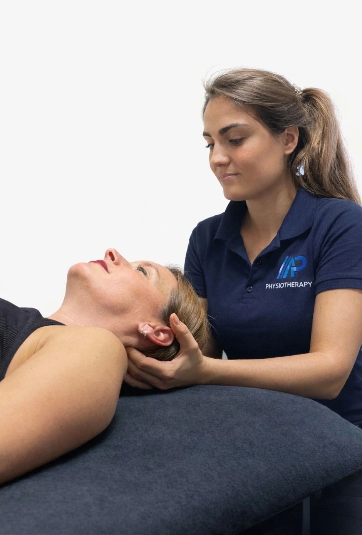 Physiotherapist providing hands-on neck treatment